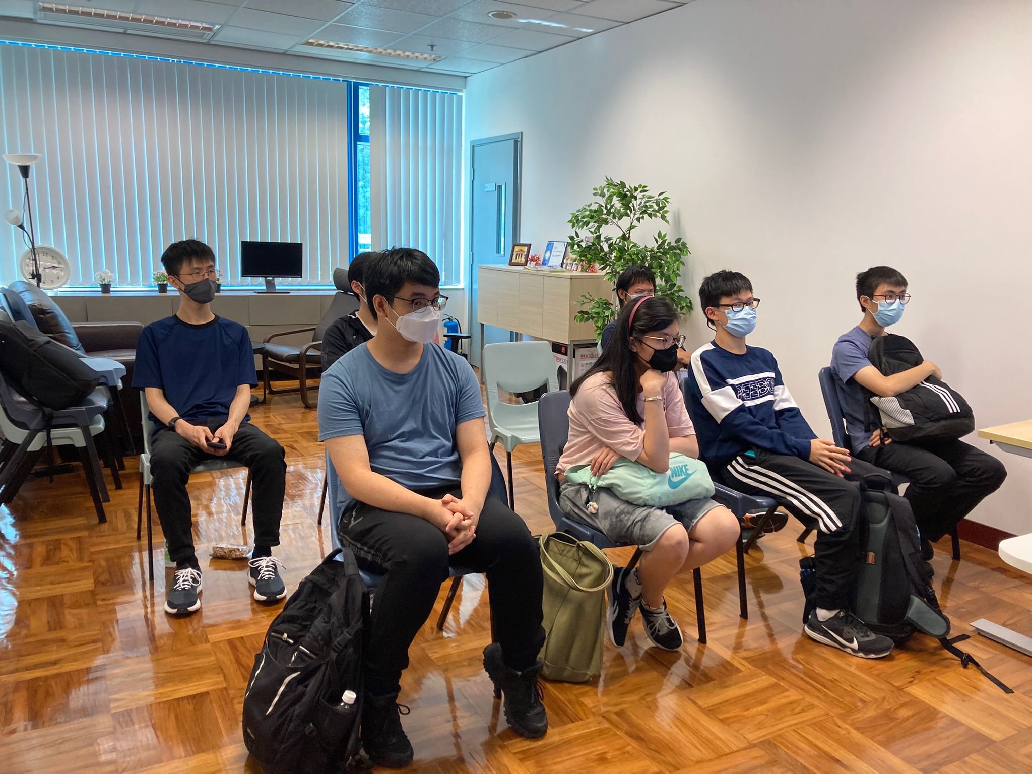 Students are listening to tutor's demonstration.