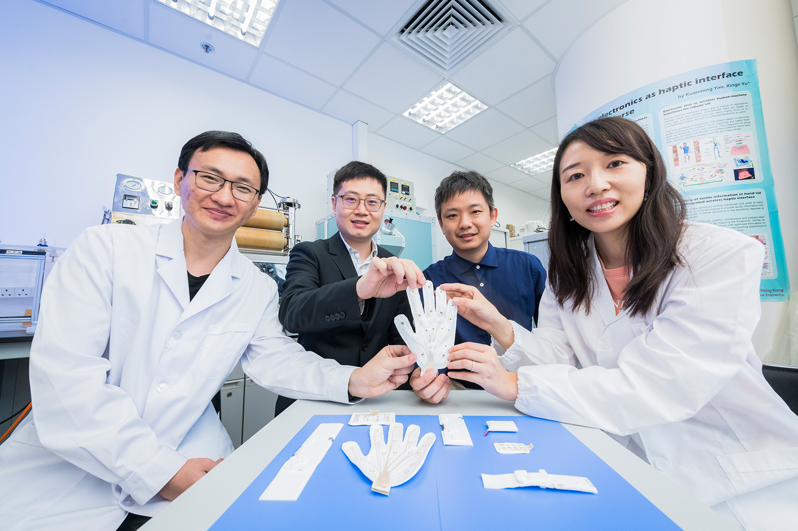 Professor Yu (second from left) and his team, (from right) Dr Huang, Professor Zhu and Mr Zhou, developed a skin-integrated multimodal haptic feedback interface.